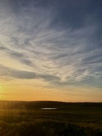 Scenic view of field against sky during sunset