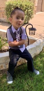 High angle view of boy sitting outdoors