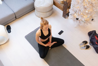 High angle view of woman sitting on floor