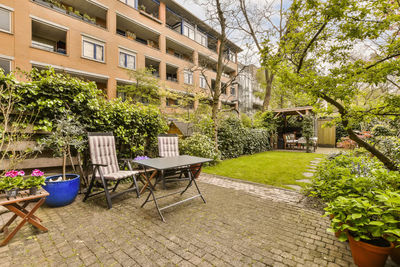 Empty chairs and tables in yard