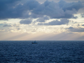 Sailboat sailing on sea against sky