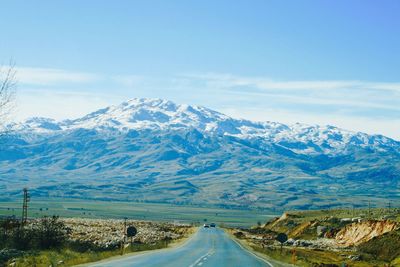 Country road leading towards mountains