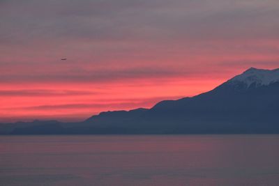 Scenic view of sea against orange sky