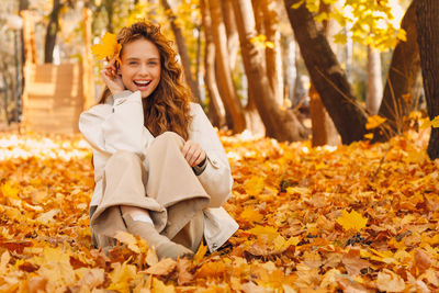 Portrait of young woman sitting on field