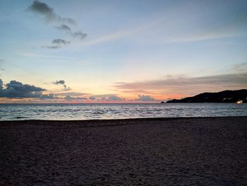 Scenic view of beach against sky during sunset