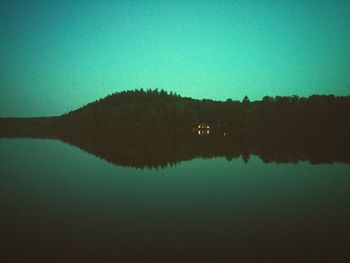 Scenic view of calm lake against clear sky