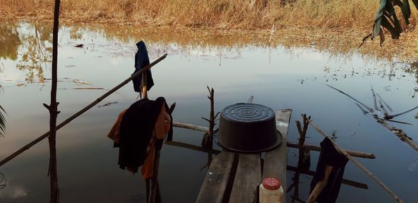 High angle view of wooden posts in lake