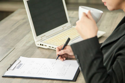 High angle view of man using mobile phone on table