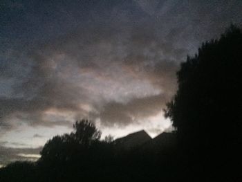 Low angle view of silhouette trees against sky at sunset