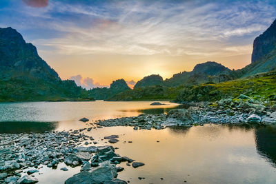 Scenic view of river against sky during sunset