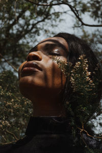 Close-up portrait of young woman with eyes closed