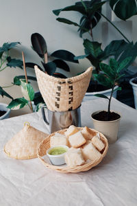 Close-up of potted plants in basket on table
