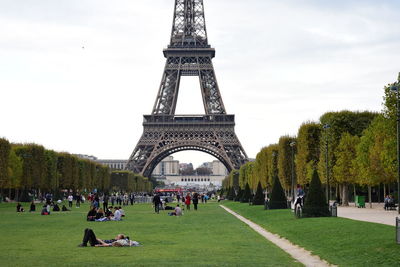 People in front of tower against sky