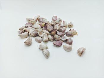 High angle view of roasted coffee beans against white background