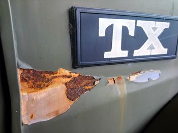 Close-up of text on rusty metal