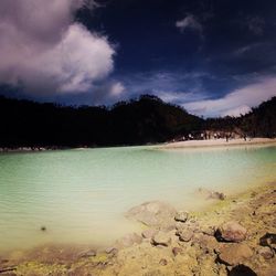 Scenic view of sea against cloudy sky