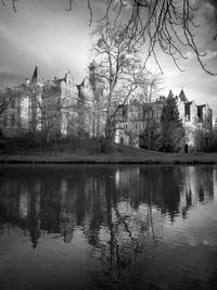 Reflection of trees and buildings in lake