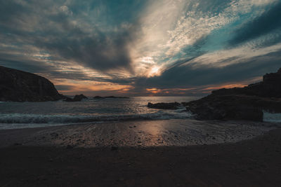 Scenic view of beach against sky during sunset