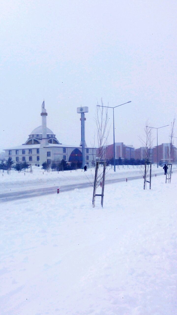 SNOW COVERED MOSQUE AGAINST SKY