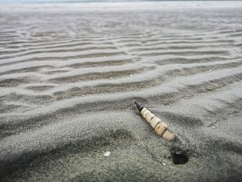 High angle view of cigarette at beach