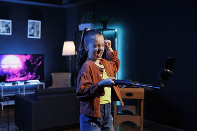 Portrait of man using mobile phone while sitting on stage