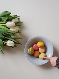 Close-up of hand holding eggs in bowl