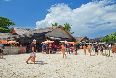 People at beach against sky