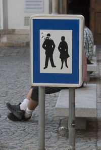 Low section of man with text on the road