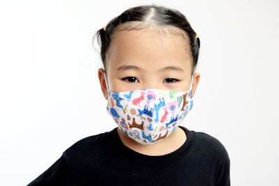 Portrait of cute baby against white background
