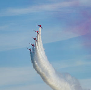 Low angle view of airplane flying against sky