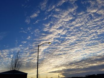 Low angle view of silhouette street light against sky