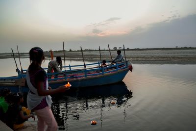 Boat in sea at sunset