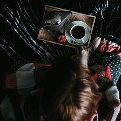 Directly above view of woman with coffee cup