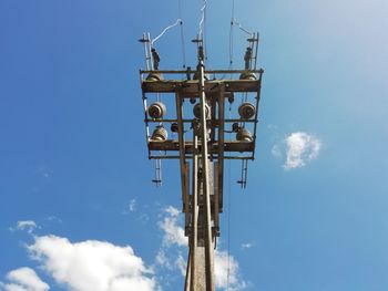 Low angle view of communications tower against sky