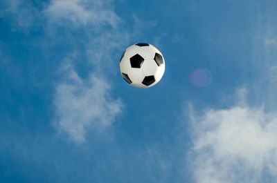 Low angle view of soccer ball against sky