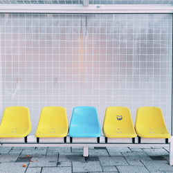 Multi colored chairs against wall