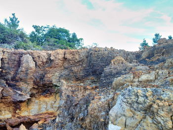 Rock formations on landscape against sky