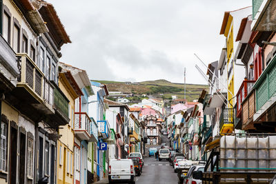 Street amidst buildings in city against sky