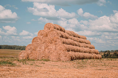 Rock formations on field against sky