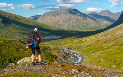 Rear view of man walking on mountain