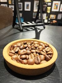 Coffee beans in plate on table