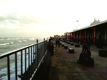 Pier on sea at sunset