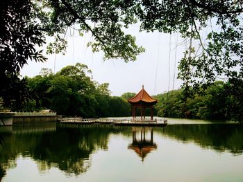 Reflection of trees in lake against sky