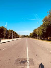 Surface level of road against blue sky