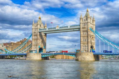 View of bridge over river against cloudy sky