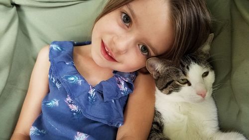 Close-up of young girl with pet cat