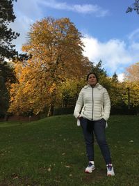 Full length of woman standing in park during autumn