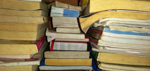 A pile of old books full of memories in a bookcase