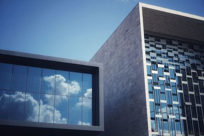 Low angle view of modern building against clear blue sky