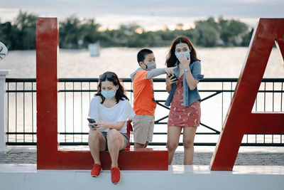 Rear view of women on railing